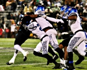 Stephenson's Danterious McKenzie (23) and Jaylen Alden (4) tackle Calhoun's Justin Beasley for a loss. (Photo by Mark Brock)