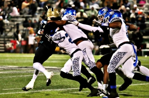 Stephenson's Danterious McKenzie (23) and Jaylen Alden (4) tackle Calhoun's Justin Beasley for a loss. (Photo by Mark Brock)