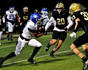 Stephenson receiver Julius Favors (9) gets up field after a catch as Calhoun defenders Alex Upshaw (30) and Jake Jordan (33) close in for the stop. Favors picked up a big 12 yards and a first down to keep the Jaguars opening drive for a touchdown alive. (Photo by Mark Brock)