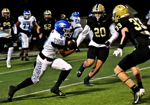 Stephenson receiver Julius Favors (9) gets up field after a catch as Calhoun defenders Alex Upshaw (30) and Jake Jordan (33) close in for the stop. Favors picked up a big 12 yards and a first down to keep the Jaguars opening drive for a touchdown alive. (Photo by Mark Brock)