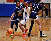 Southwest DeKalb's Saniya Rice (30) dribbles to get past Columbia defender Deasia Kelly (middle) who is trying to get around a screen by Rice teammate Chance Alexander. (Photo by Mark Brock)